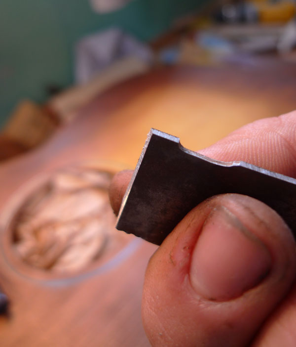 I ground a scraper out of an old bandsaw blade to clear the rosette of sunburst/sealer, it does a wonderful job of scraping the whole rosette at one go.